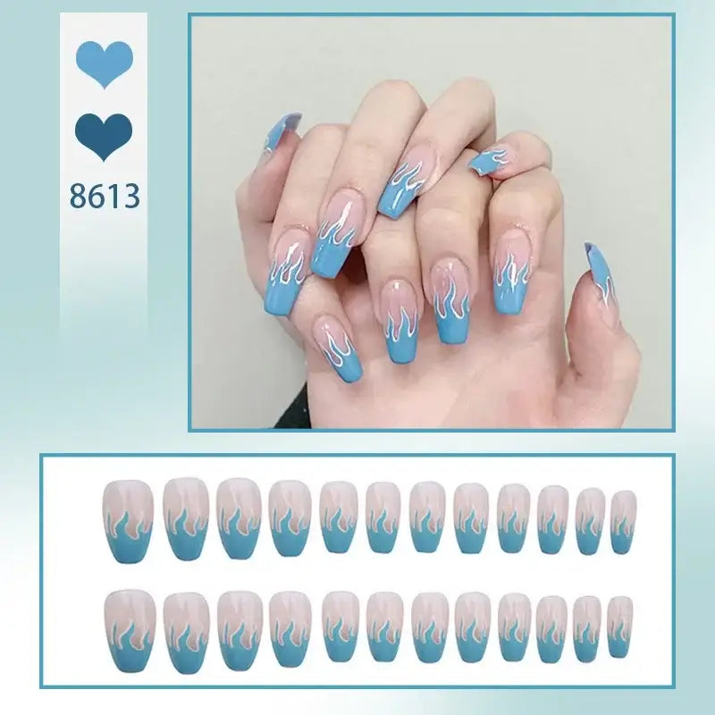 Manicured nails with blue ombre tips and white flame designs.