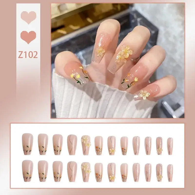 Manicured nails with gold foil accents and delicate designs.