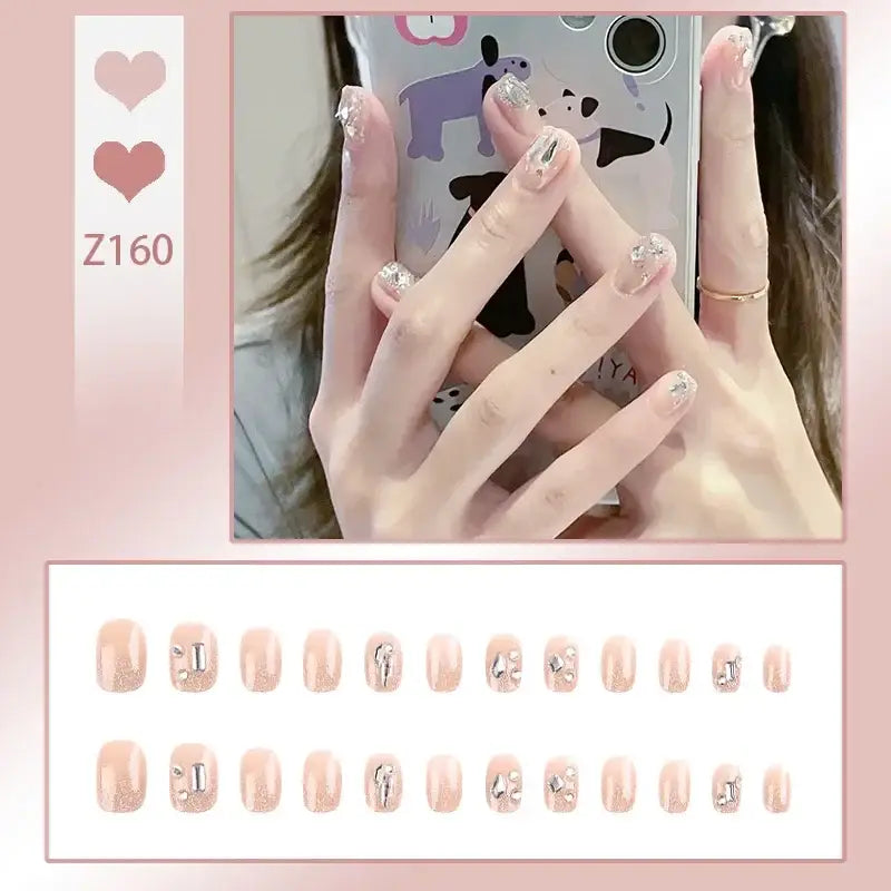 Set of artificial nails with delicate floral and numeric designs on a pale pink base.