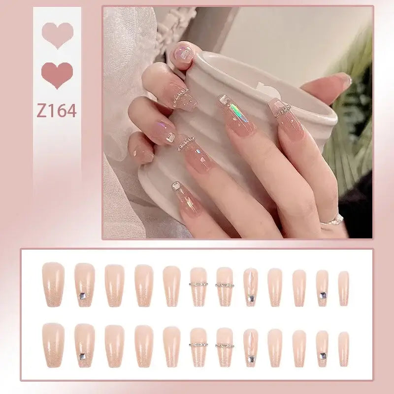 Set of artificial nails in nude and pastel pink shades with delicate floral and glitter accents.