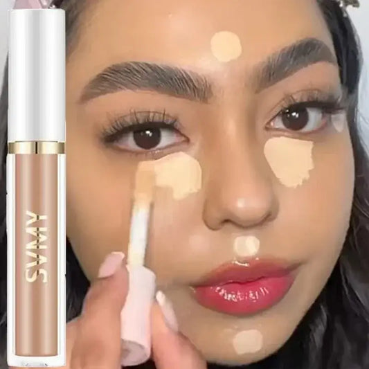 Concealer or liquid foundation makeup product being applied to a person’s face.