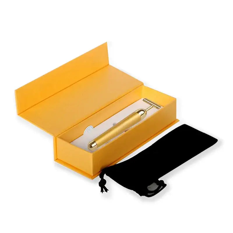 Gold-colored pen in a yellow gift box with a separate black pouch.