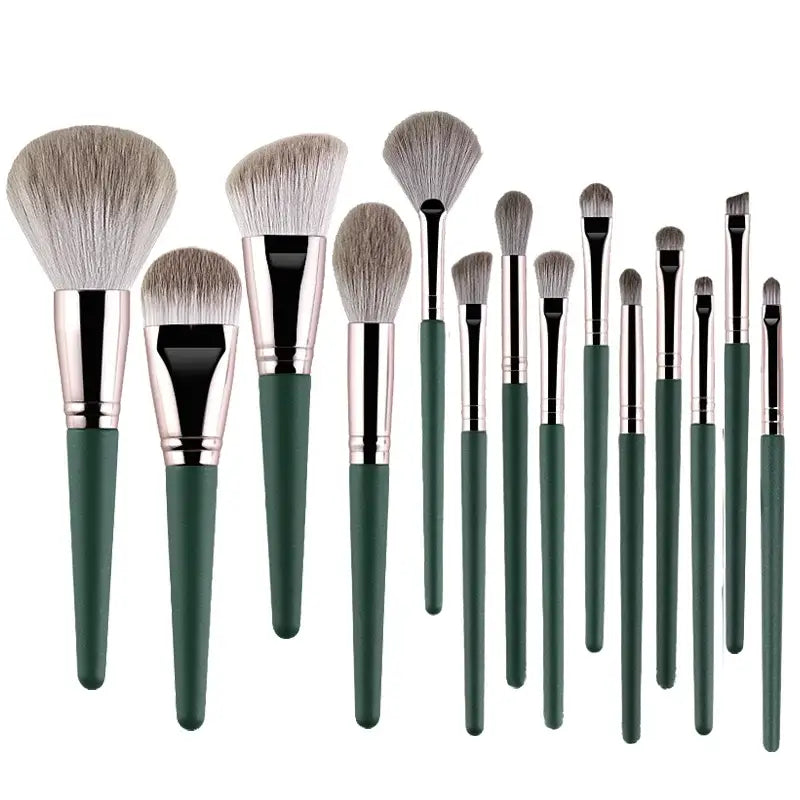 Set of makeup brushes with green handles and silver ferrules.