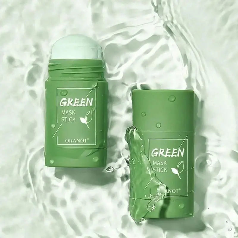 Green mask stick skincare product in cylindrical packaging.