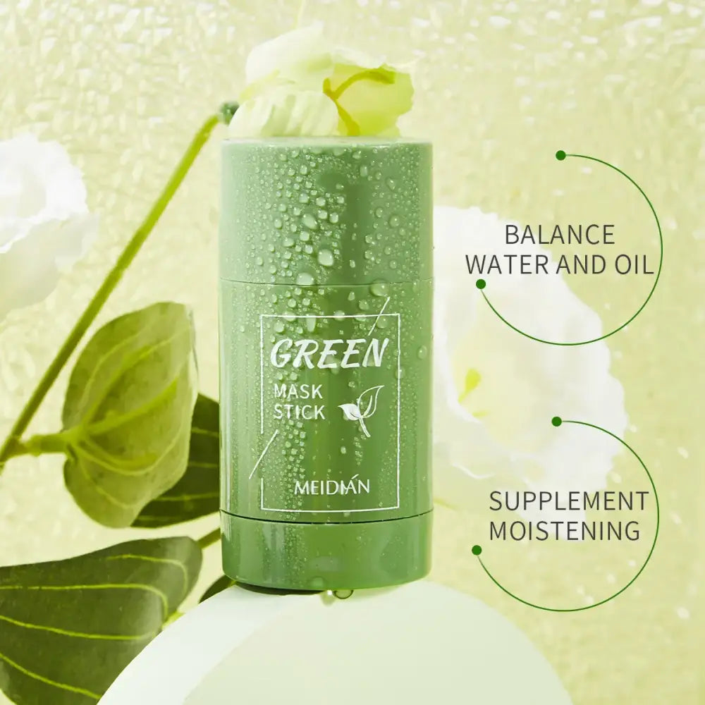 Green cylindrical skincare product labeled ’Green Mask Stick’ with water droplets on its surface.