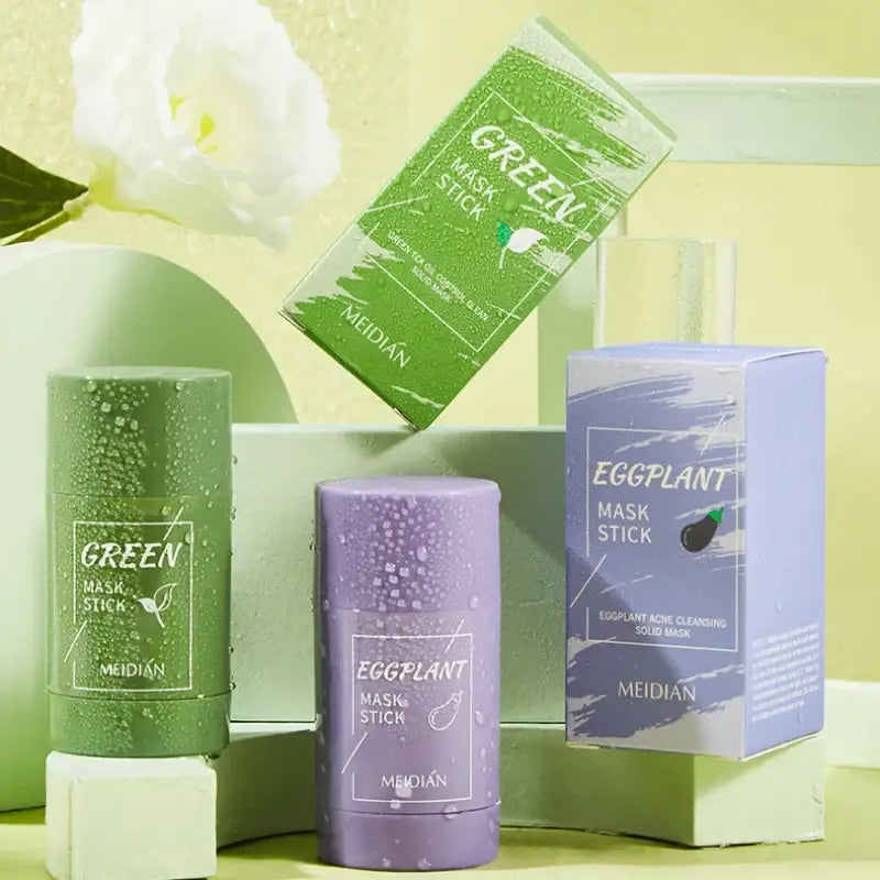 Skincare products featuring green and purple mask sticks and packaging.