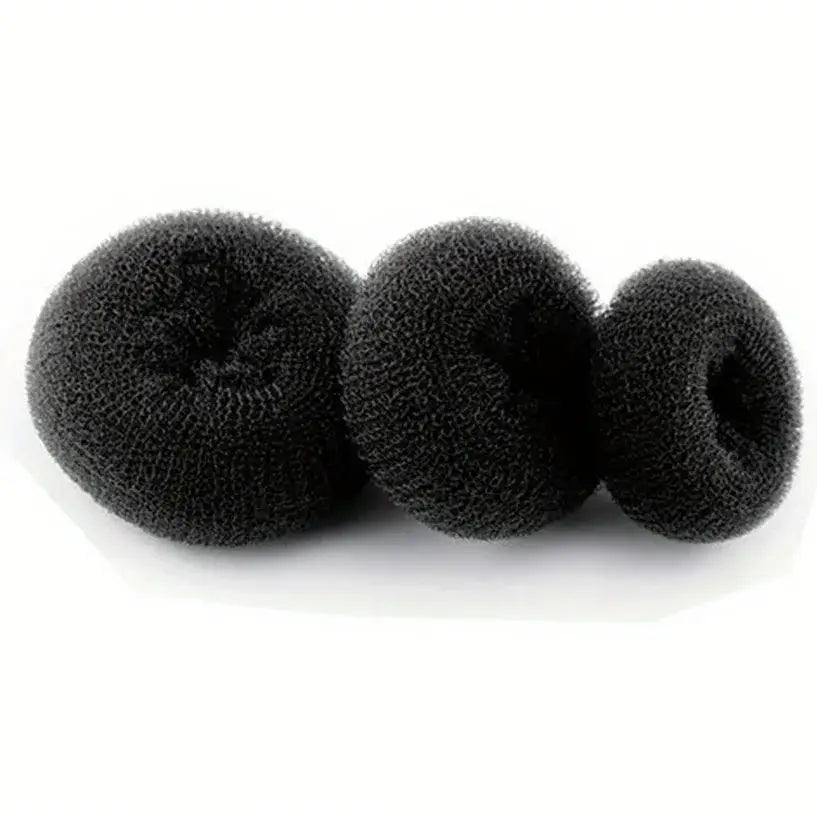 Three black hair buns or donut-shaped hair accessories of decreasing size.