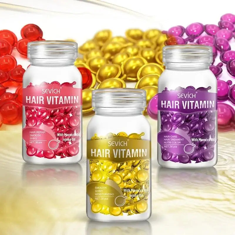 Three bottles of hair vitamin supplements in different colors (red, yellow, and purple).