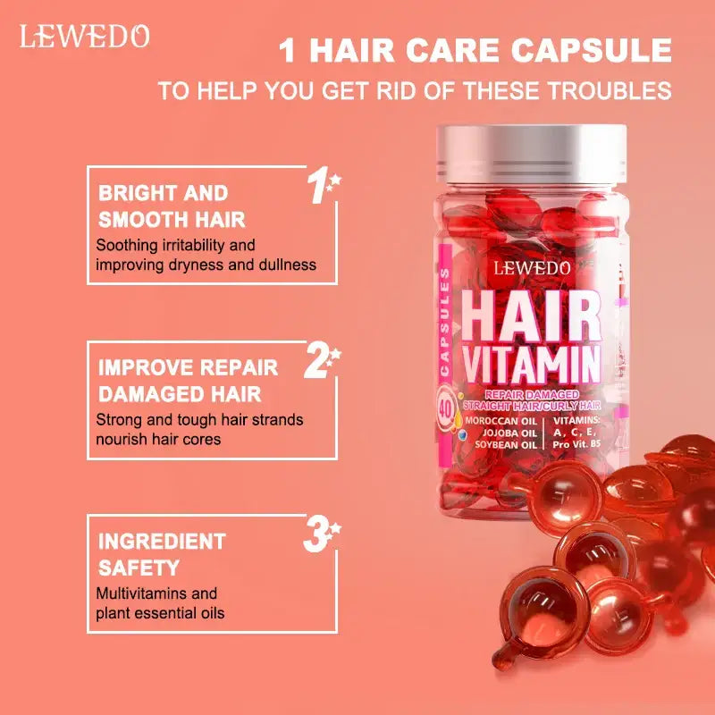 Hair vitamin capsules in a pink bottle with red gel capsules spilled beside it.