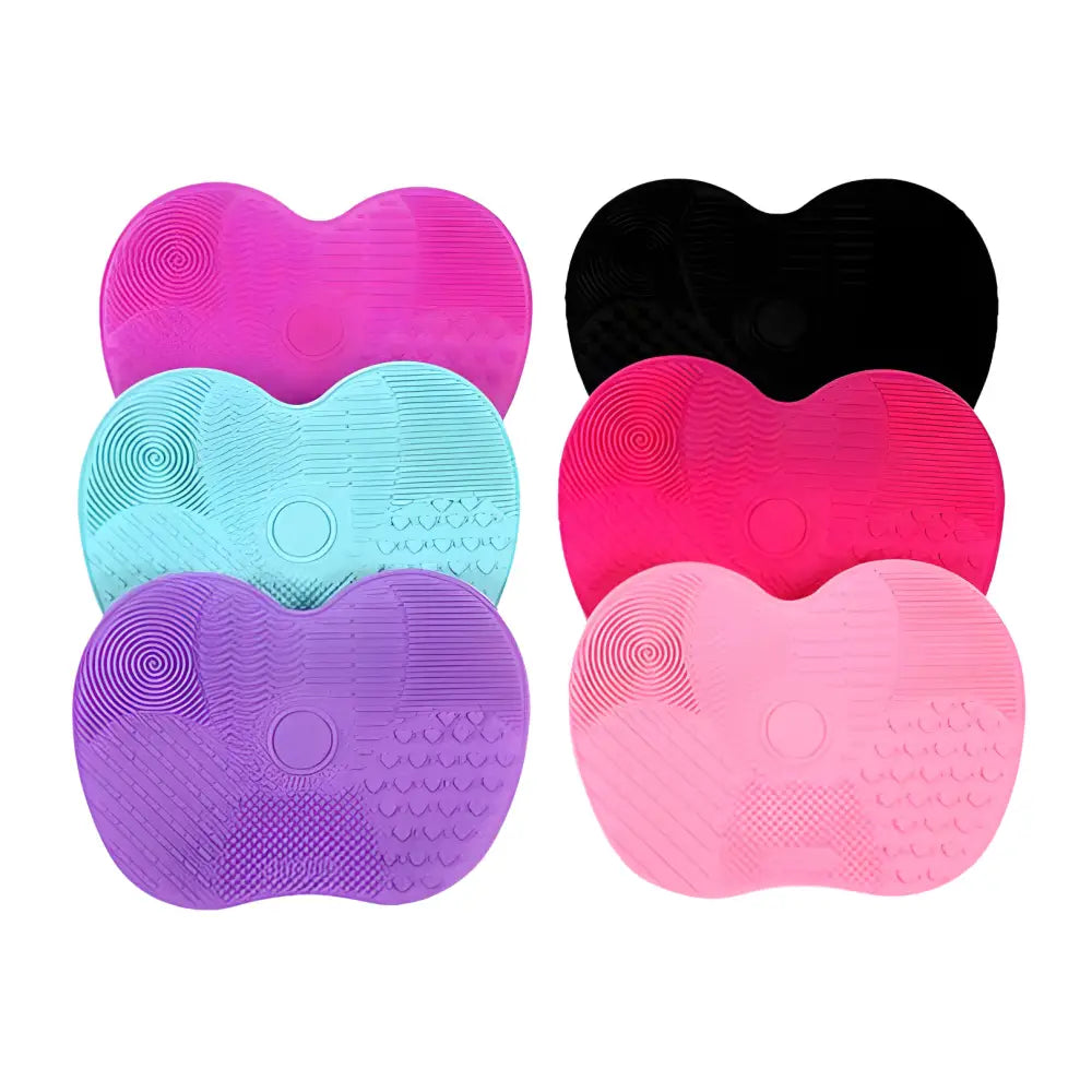 Heart-shaped silicone makeup brush cleaning pads in various bright colors.