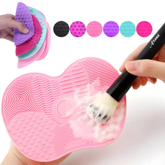 Heart-shaped silicone makeup brush cleaning pad with textured surfaces.