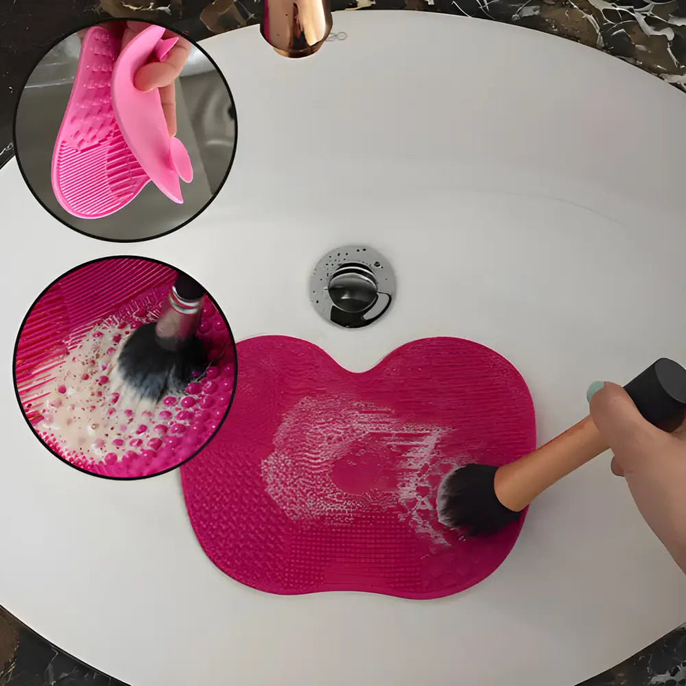 Pink silicone makeup brush cleaning mat with textured surfaces.