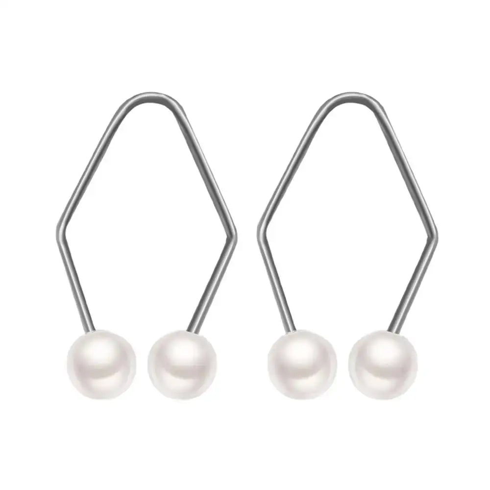 Pearl earrings with diamond-shaped silver wire hooks.