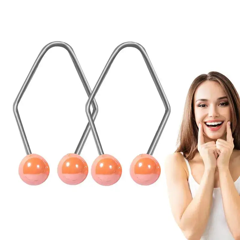 Facial massage tool with four orange spheres attached to metal wires in an X-shape.