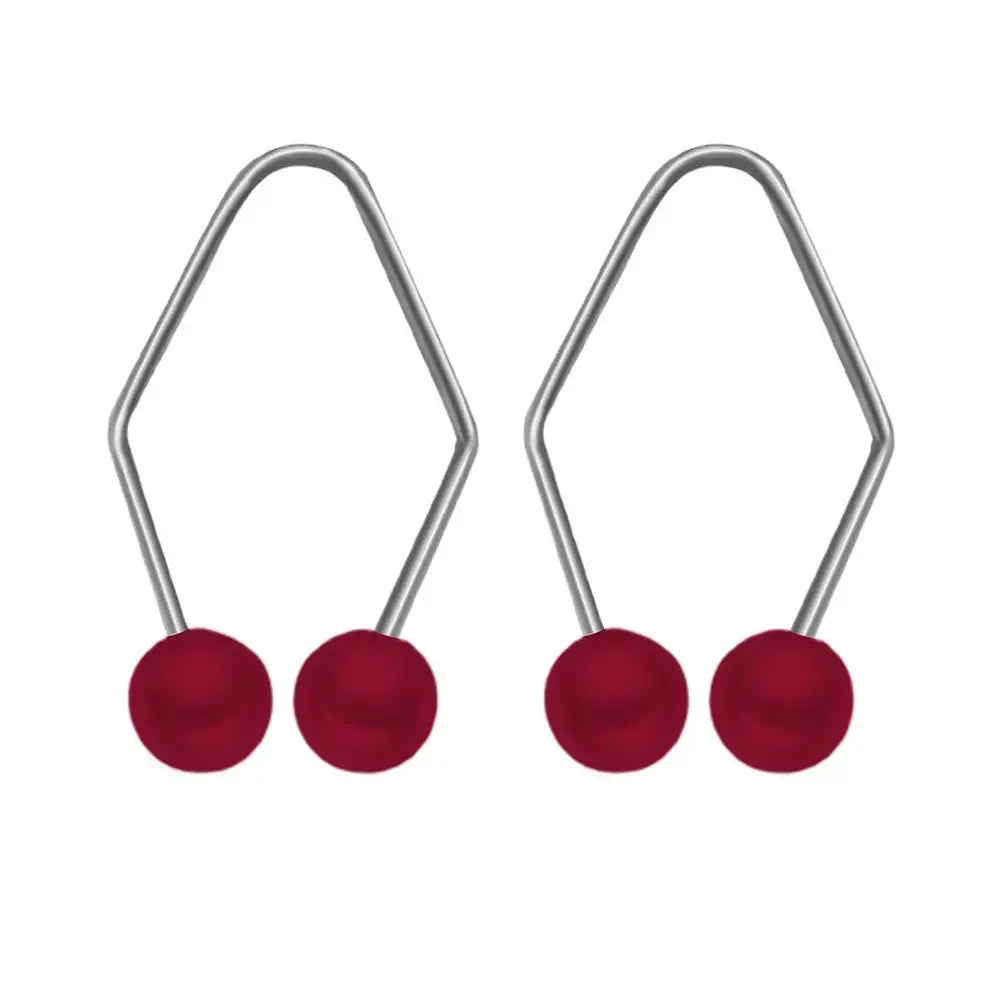 Two pairs of silver earrings with red spherical beads at the ends.