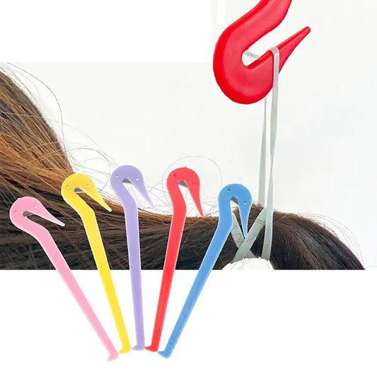 Colorful plastic hair clips with curved hook-like shapes.