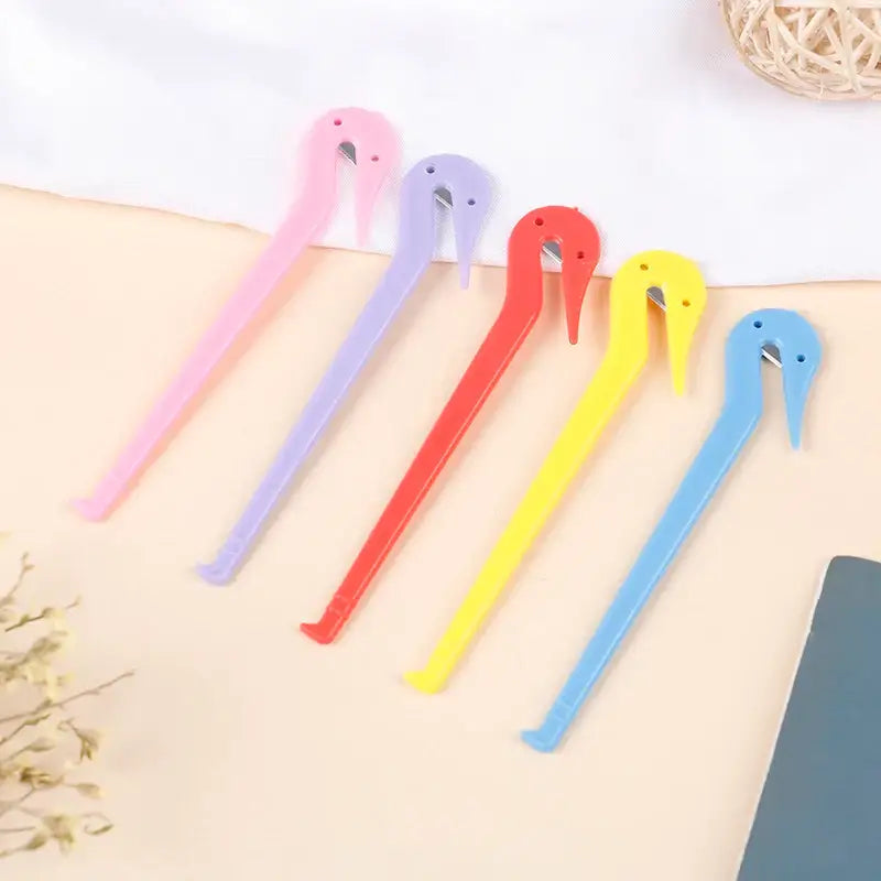 Colorful plastic tweezers with animal-shaped heads.