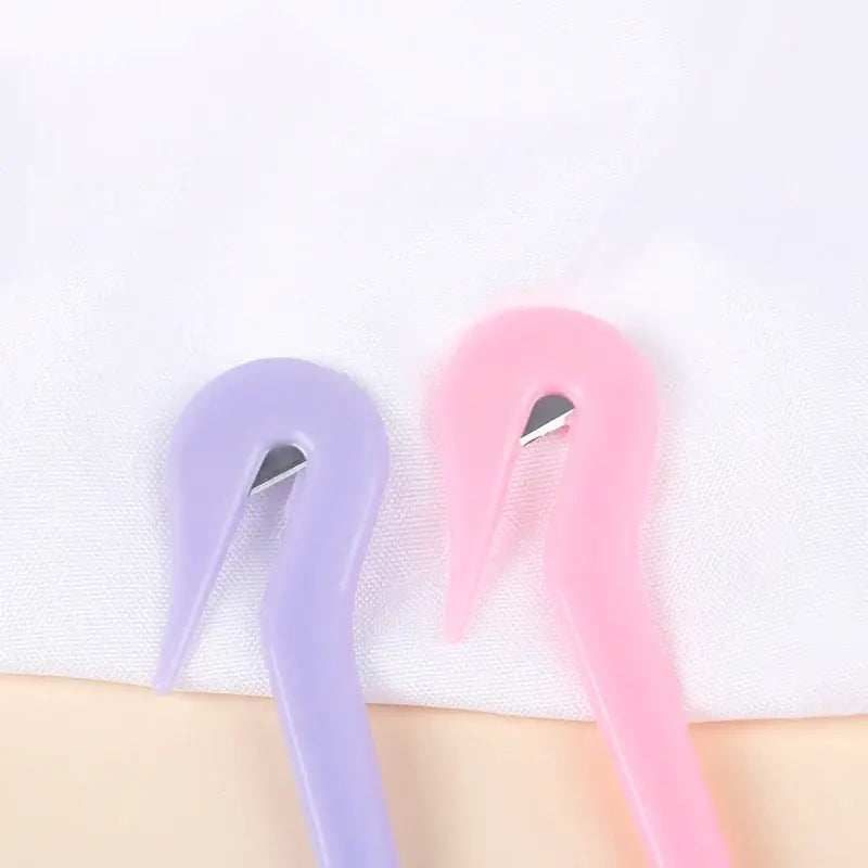 Two flamingos with long, curved necks in pastel purple and pink.