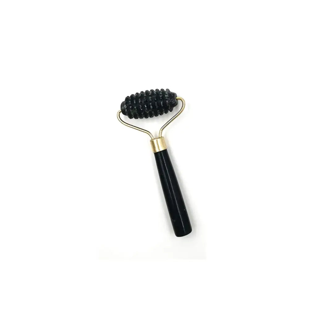 Facial massage roller with a black handle and metal head containing short bristles.