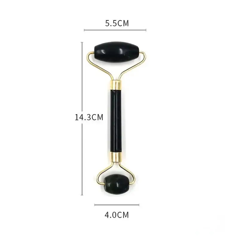 Facial massage roller with black stone ends and gold-colored metal handle.