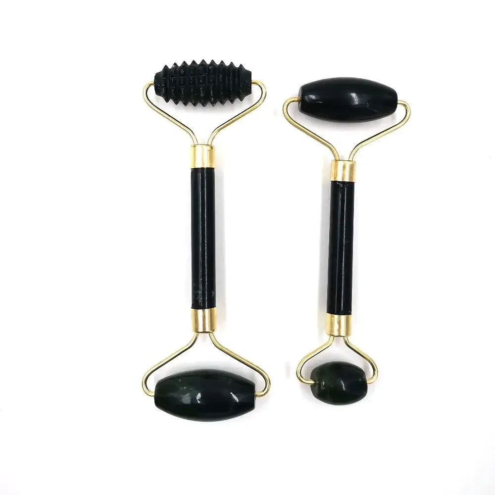 Facial massage rollers with black handles and gold-colored metal frames.