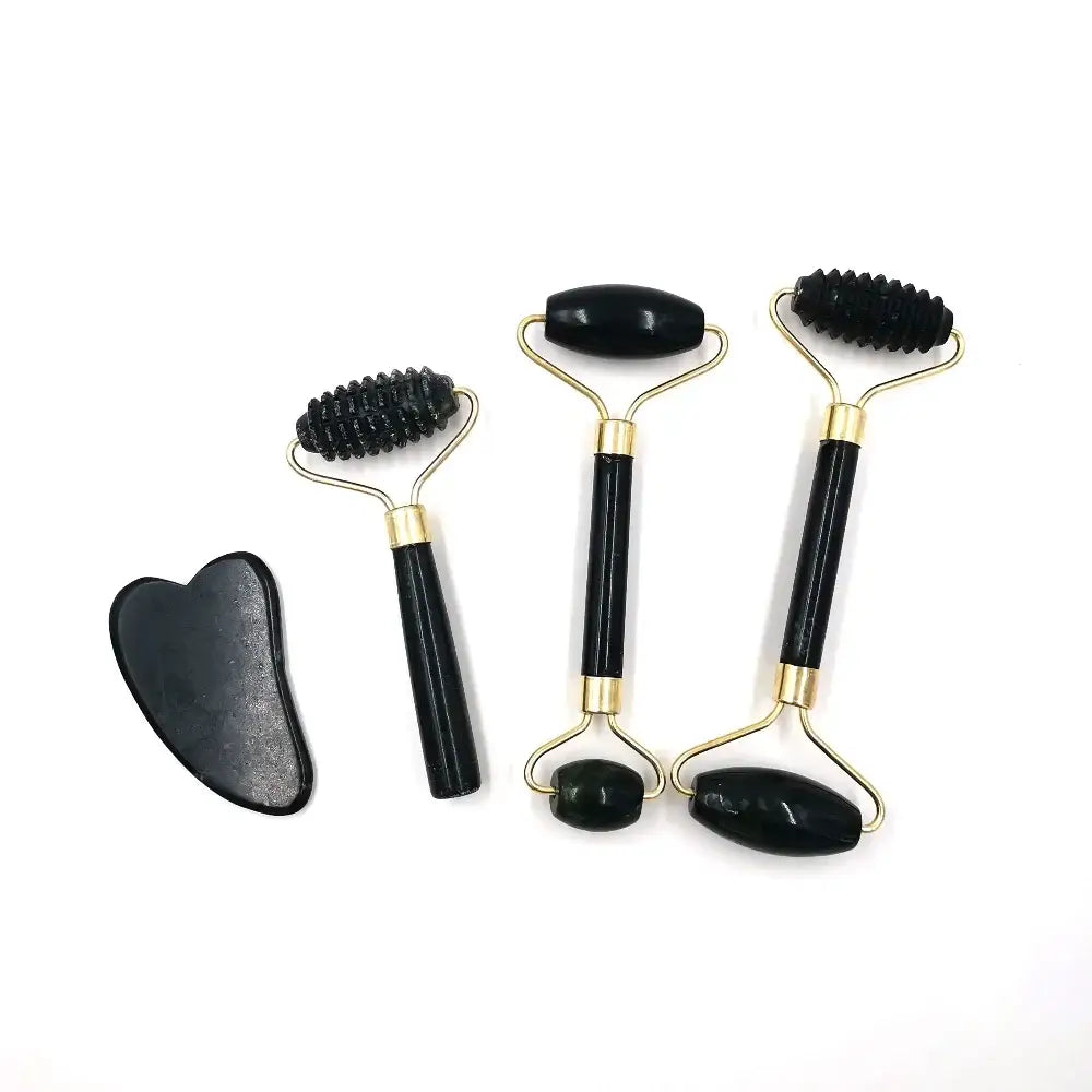 Set of facial massage tools including rollers and a gua sha stone.