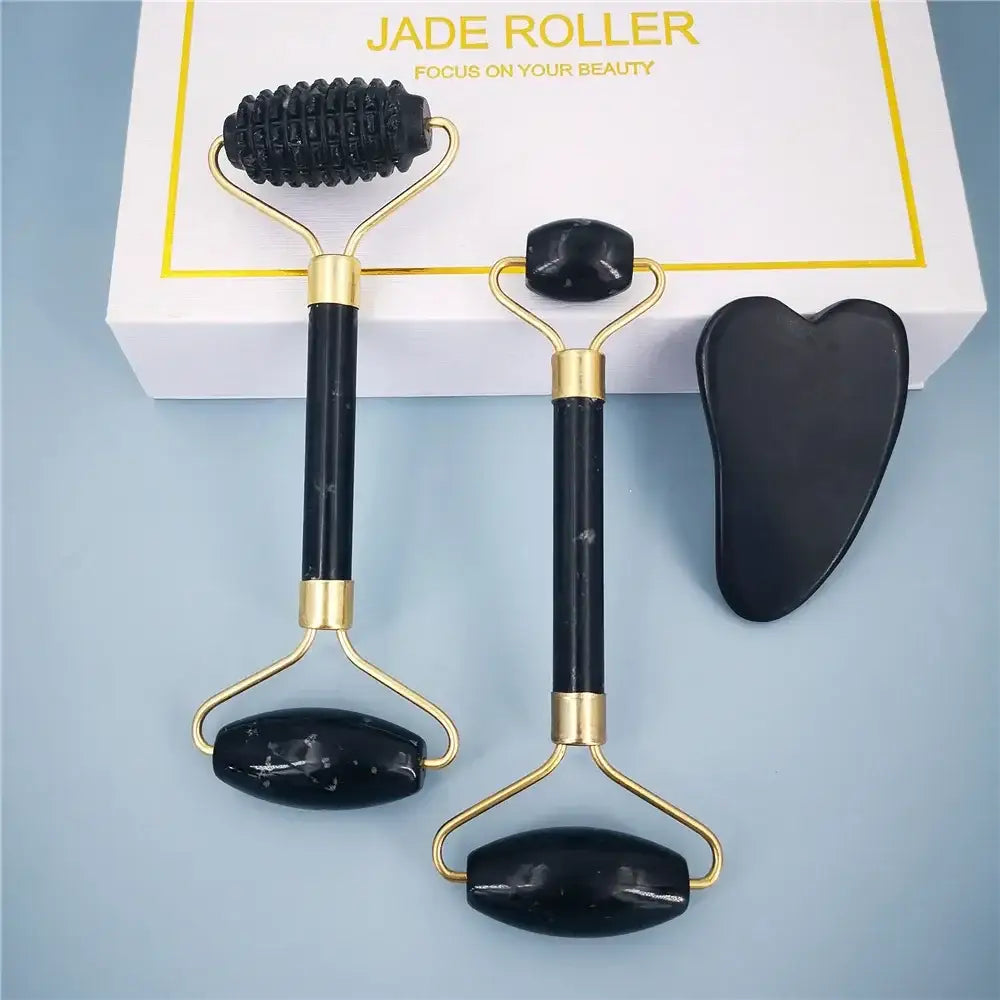 Jade roller set with three black facial massage tools featuring gold-colored handles.