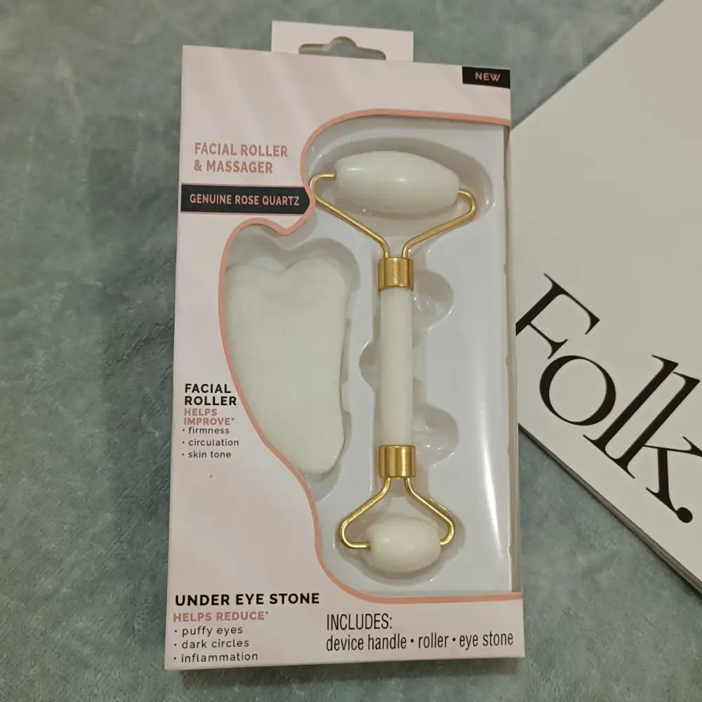 Facial roller and massager set with a white handle and gold-colored metal parts.