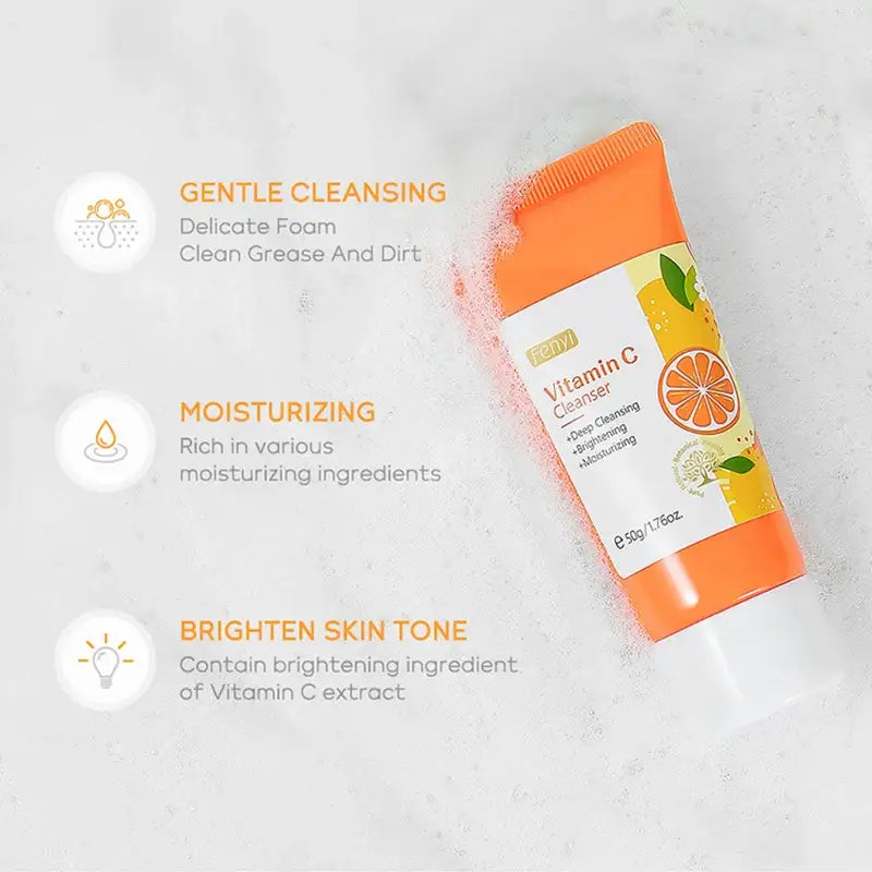 Orange-colored tube of Vitamin C facial cleanser with citrus fruit imagery.