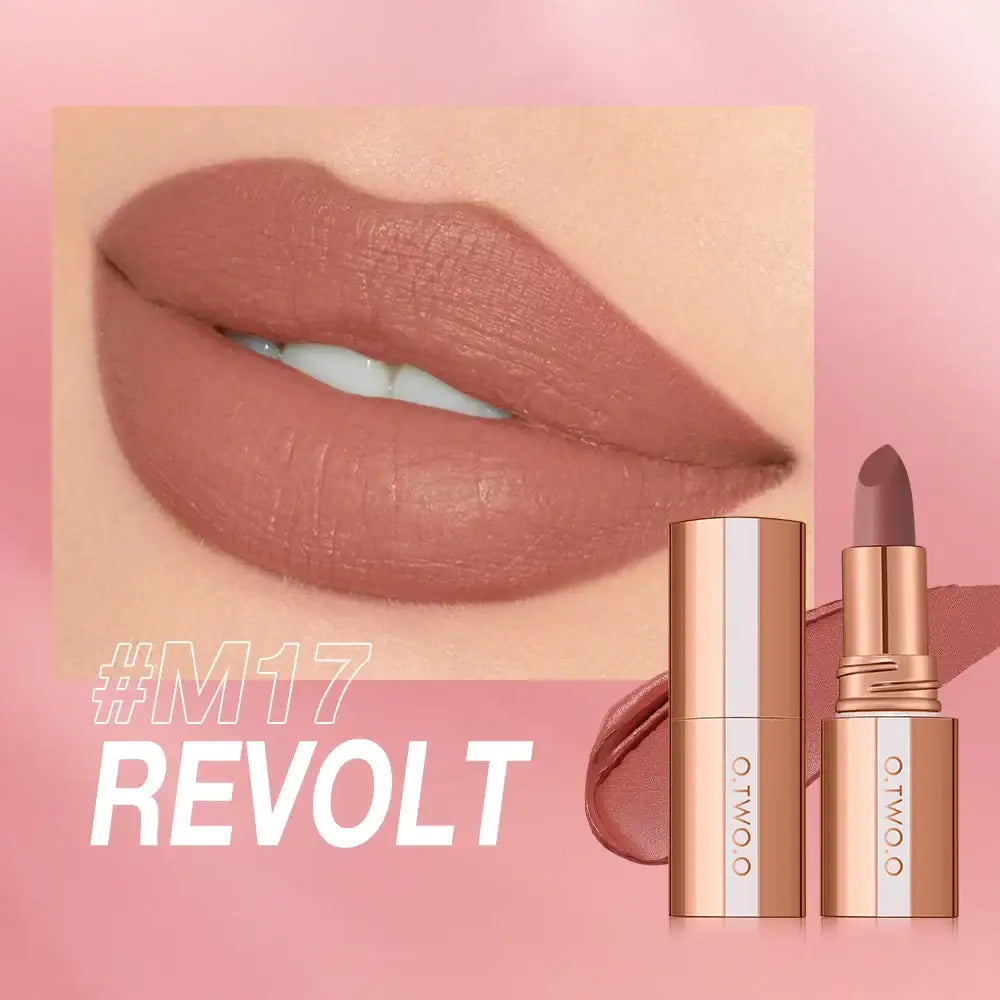 Plump lips wearing matte nude lipstick alongside a gold lipstick tube.