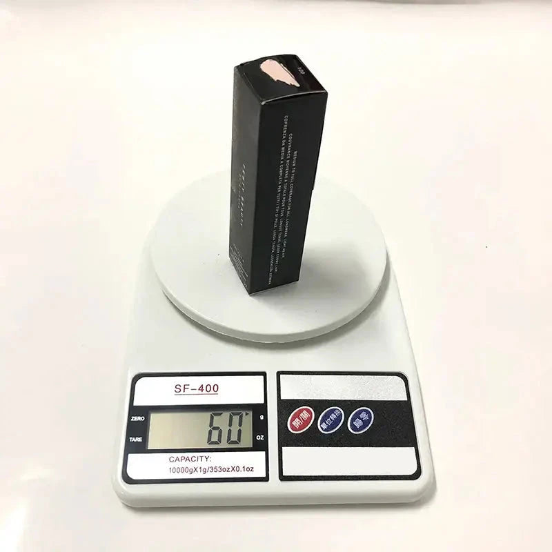 Black rectangular cosmetic product box on a digital scale displaying 60 grams.