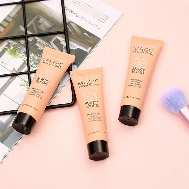 Three tubes of ’Magic’ brand beauty products in peach-colored packaging.