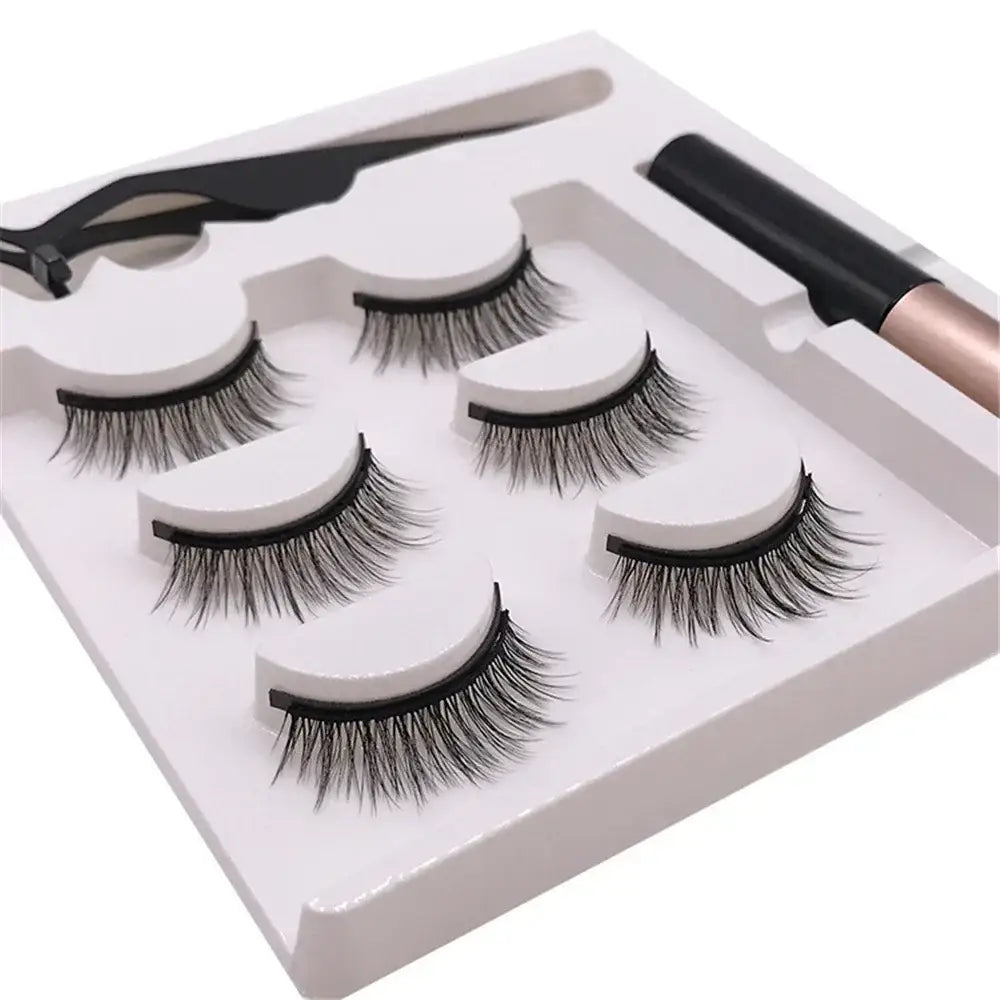 Set of false eyelashes with an applicator tool.