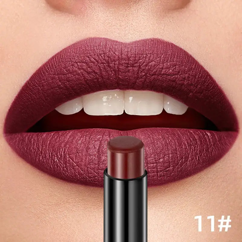 Deep burgundy lipstick applied to full, plump lips.