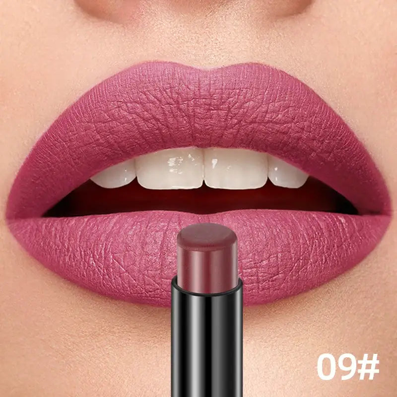 Vibrant pink lipstick applied to full lips, with a matching lipstick tube below.