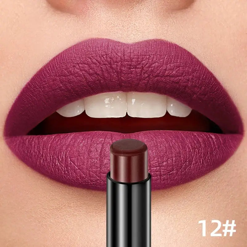 Vibrant purple lipstick applied to lips with a matching lipstick tube below.