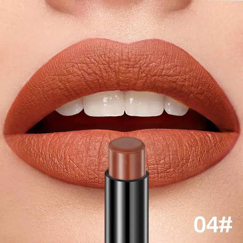 Lipstick in a warm terracotta shade next to lips wearing the same color.