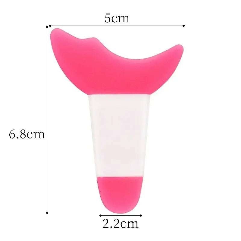 Pink and white silicone device with a curved top and cylindrical base.