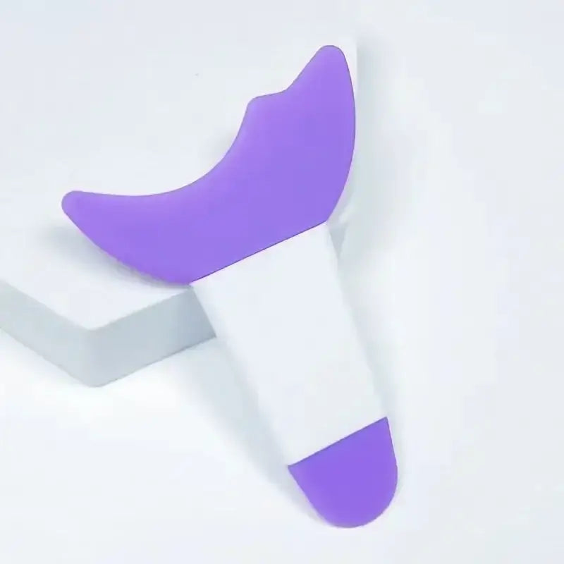 Purple and white vibrator or personal massager device.