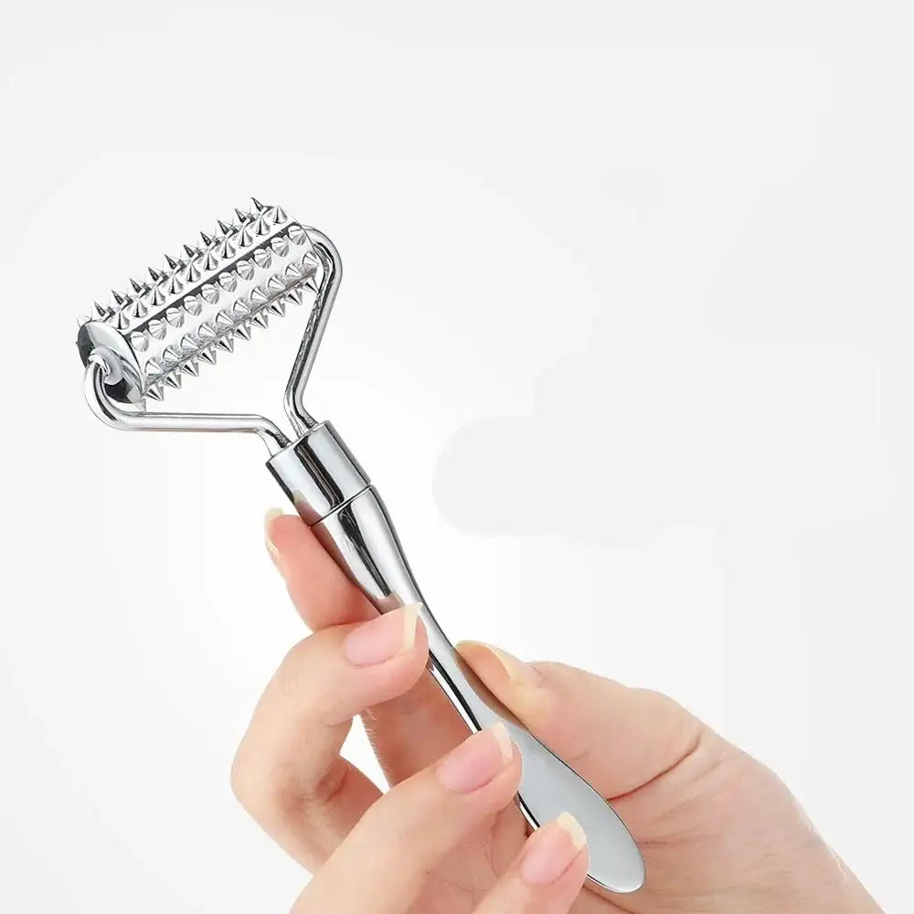 Handheld facial massage roller with spiked metal wheel and ergonomic handle.