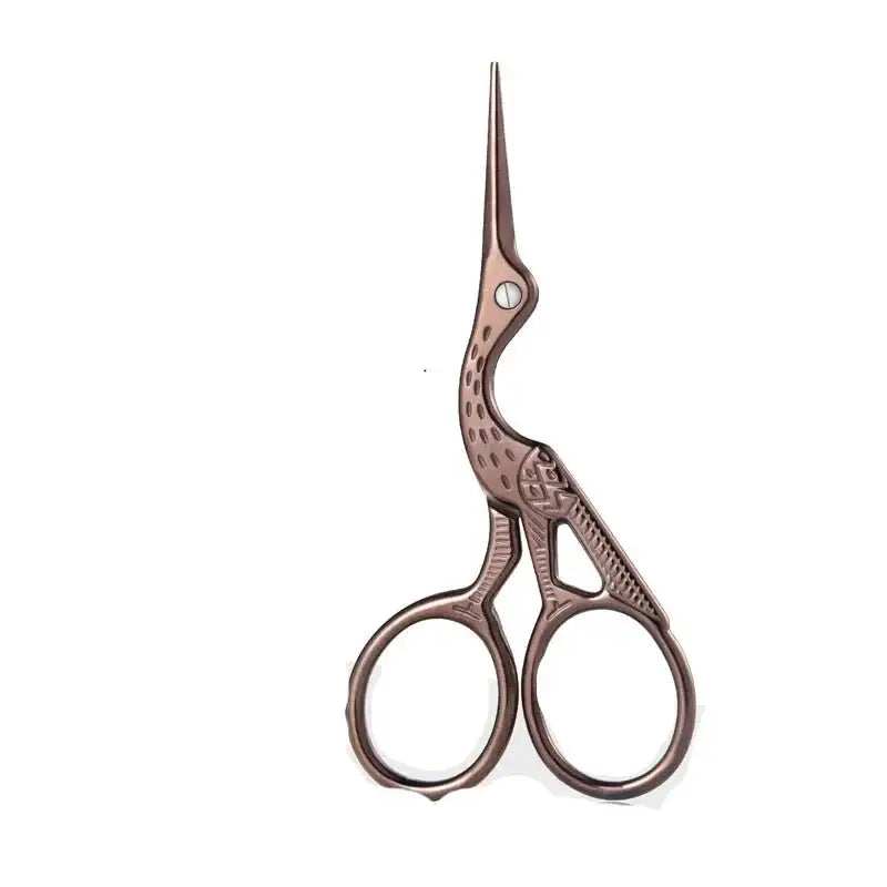 Ornate scissors shaped like a long-necked bird with intricate patterning on the handles.