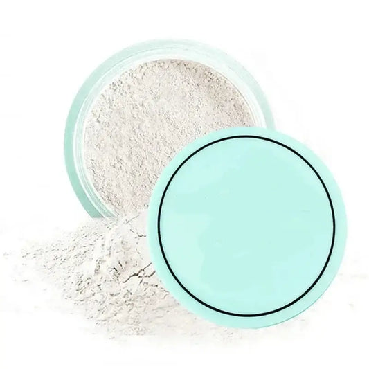 Mint green compact powder container with loose white powder spilling out.