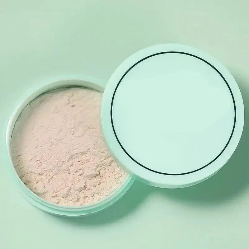 Compact powder makeup in a round container with an open lid.