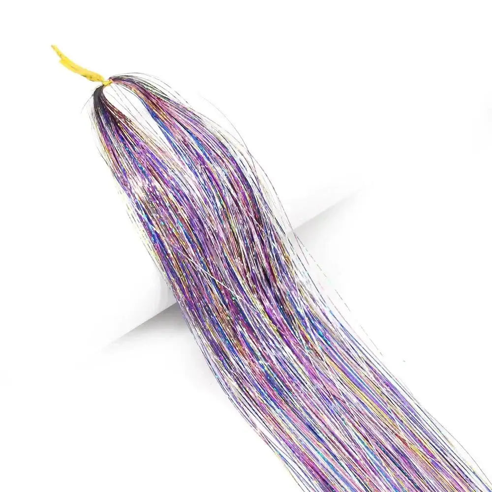 Colorful bundle of shimmering tinsel strands with purple, blue, and silver hues.