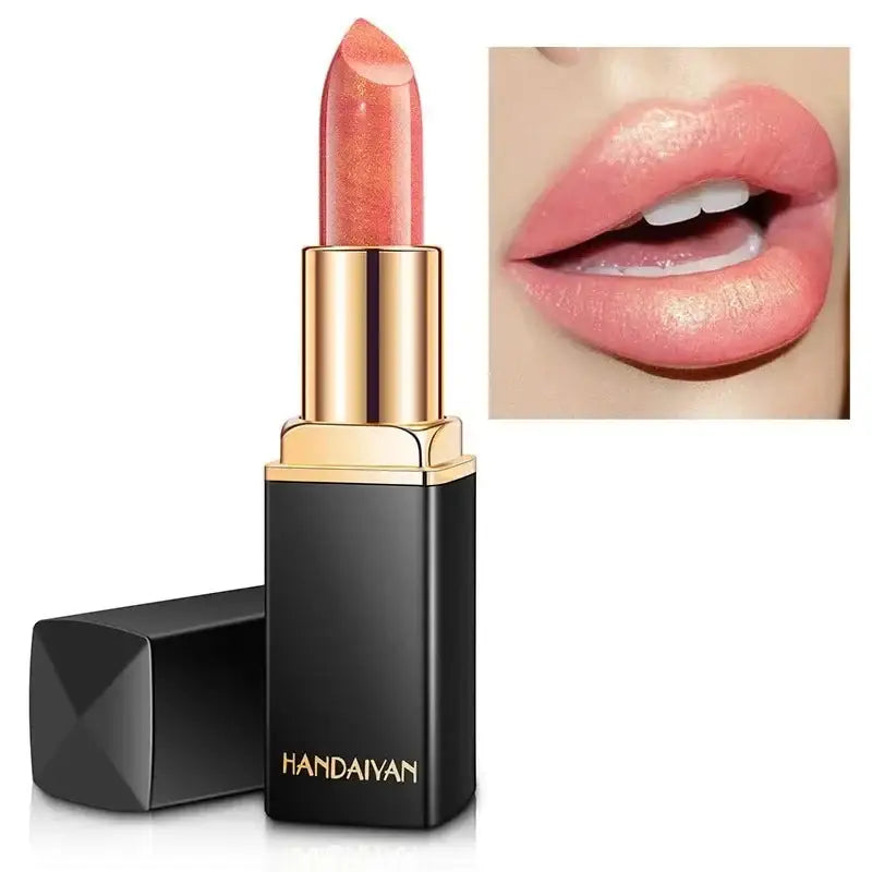 Peach-colored lipstick in a black and gold tube.