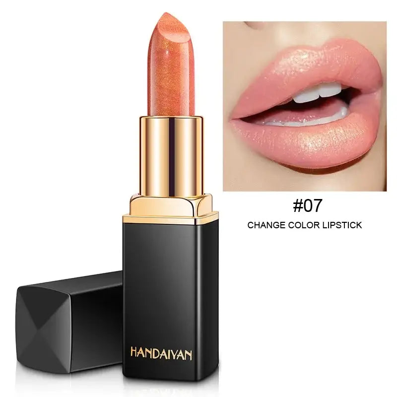 Peach-colored lipstick in a black and gold tube.