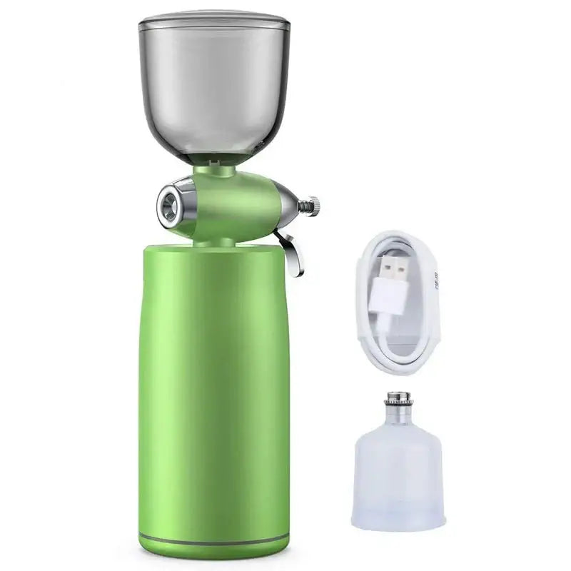 Portable electric coffee grinder with a green cylindrical body and metal hopper on top.