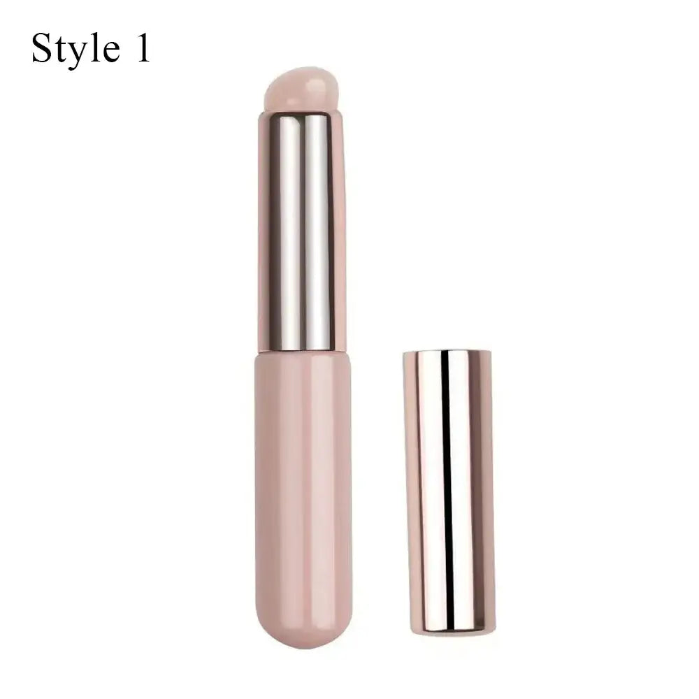 Pale pink lipstick or lip balm tube with a metallic silver cap.