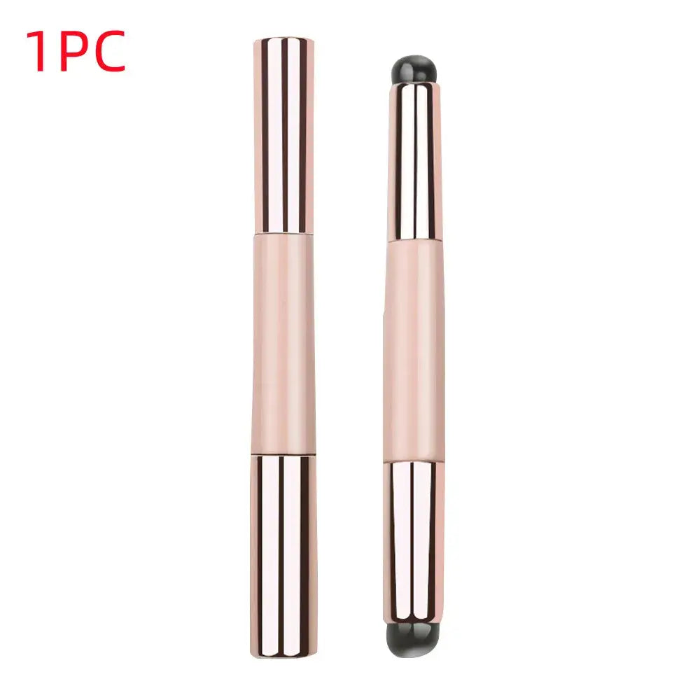 Sleek, rose gold makeup brush with dual ends for application and blending.