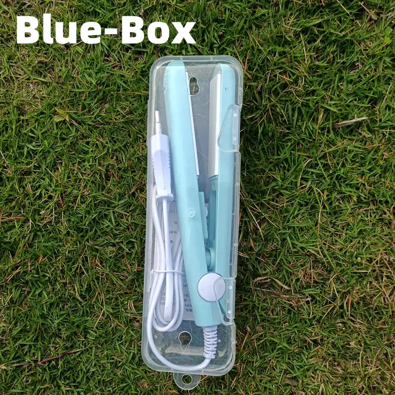 Mint green hair straightener or flat iron in a clear plastic case.